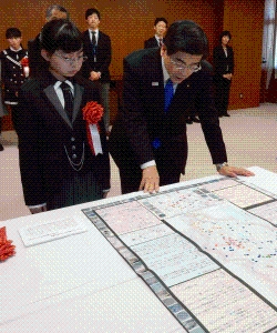 写真:石井国土交通大臣に作品の説明をする小西さん
